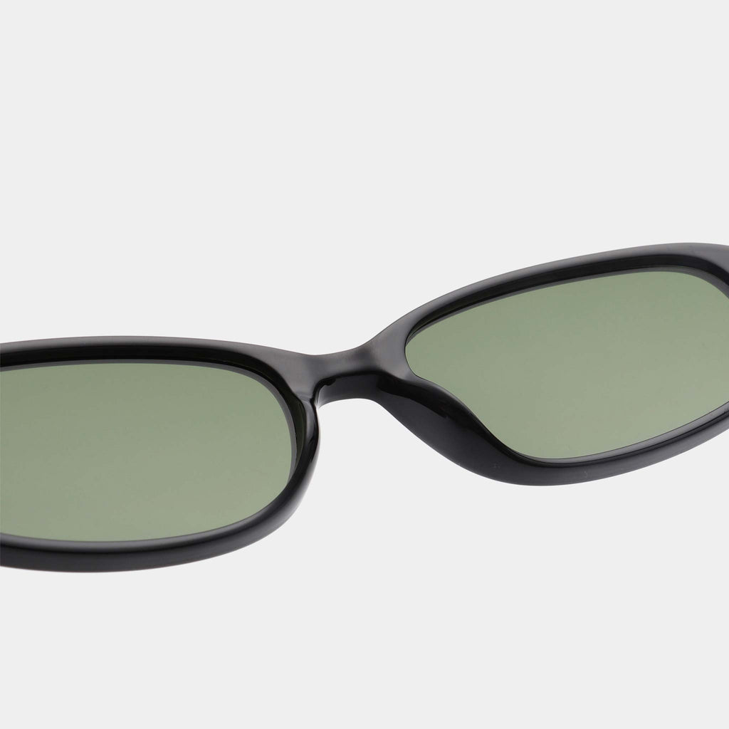 Sunglasses with black frame and green lenses on a white background.