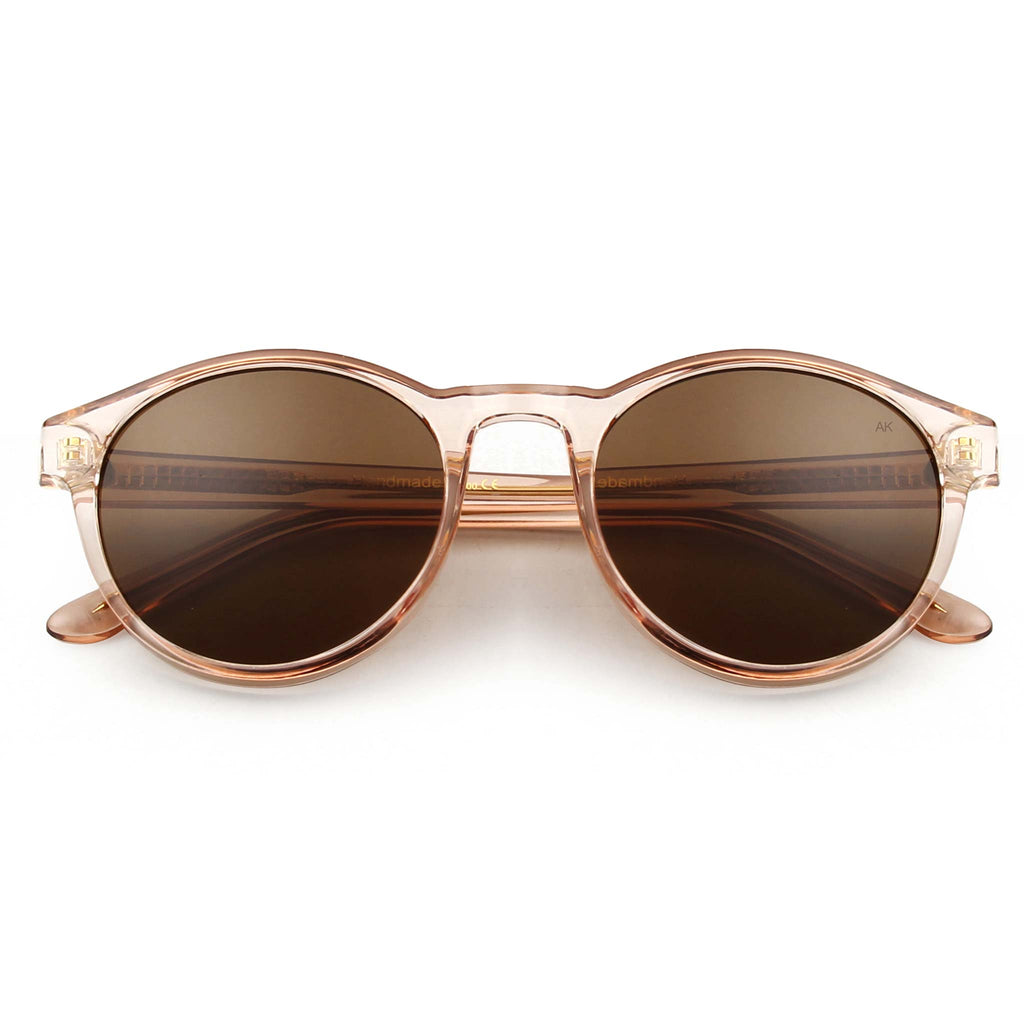 Marvin is a classic yet minimal shape and an effortless everyday choice. These UV protective sunglasses feature brown lenses and champagne pink frames.