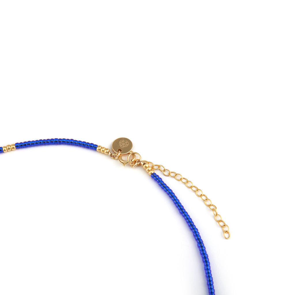 The Morocco blue Beaded Necklace is a choker style necklace, featuring gold fill chain making it adjustable. Finished with our signature gemstone branded tag. 