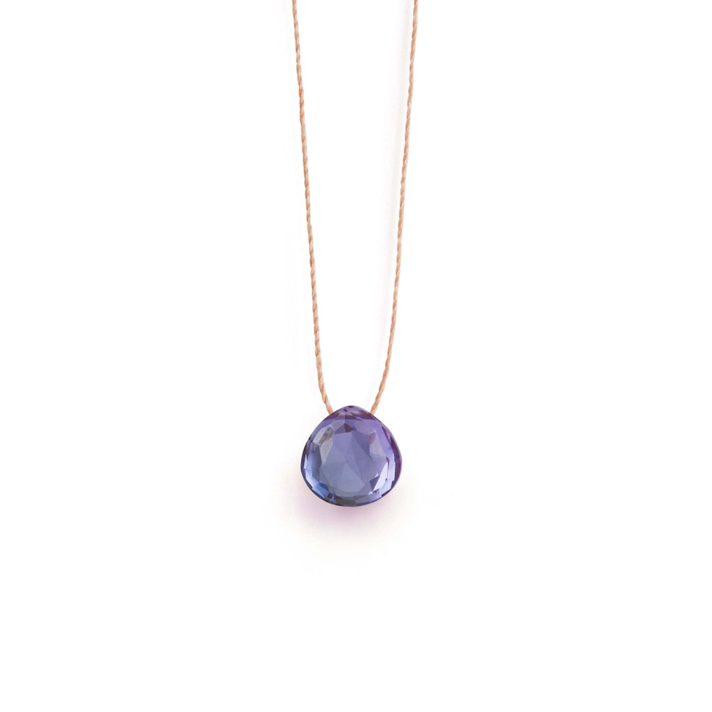 An Alexandrite Quartz Gemstone is strung on a fine cord, forming a minimal and modern gemstone necklace. Alexandrite Quartz is a gemstone that appears both blue and purple in colour, cut in our signature faceted shape.