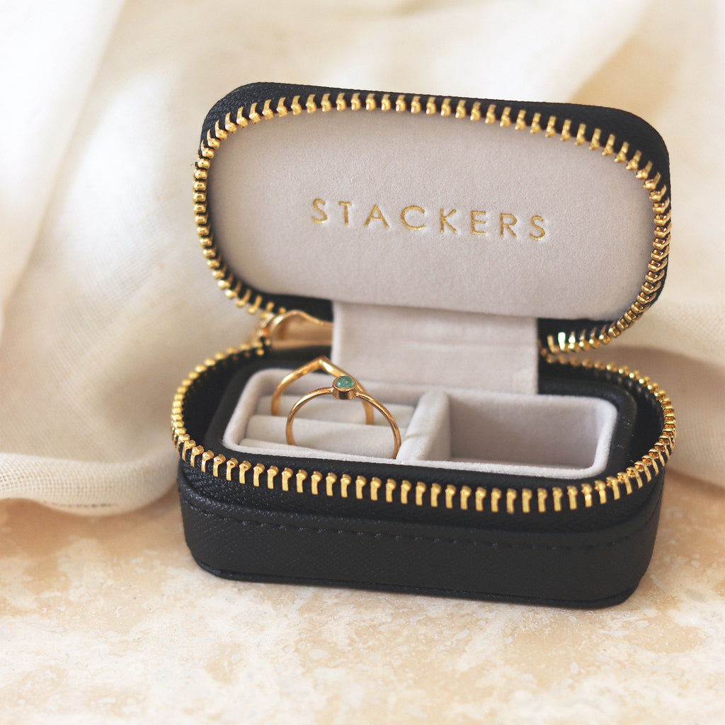 Petite faux leather jewellery travel box with zip. A stocking filler and gifting go-to, this little case organises and stores jewellery. Perfect for holding rings and studs, this travel case easily fits in your handbag or gymbag. 