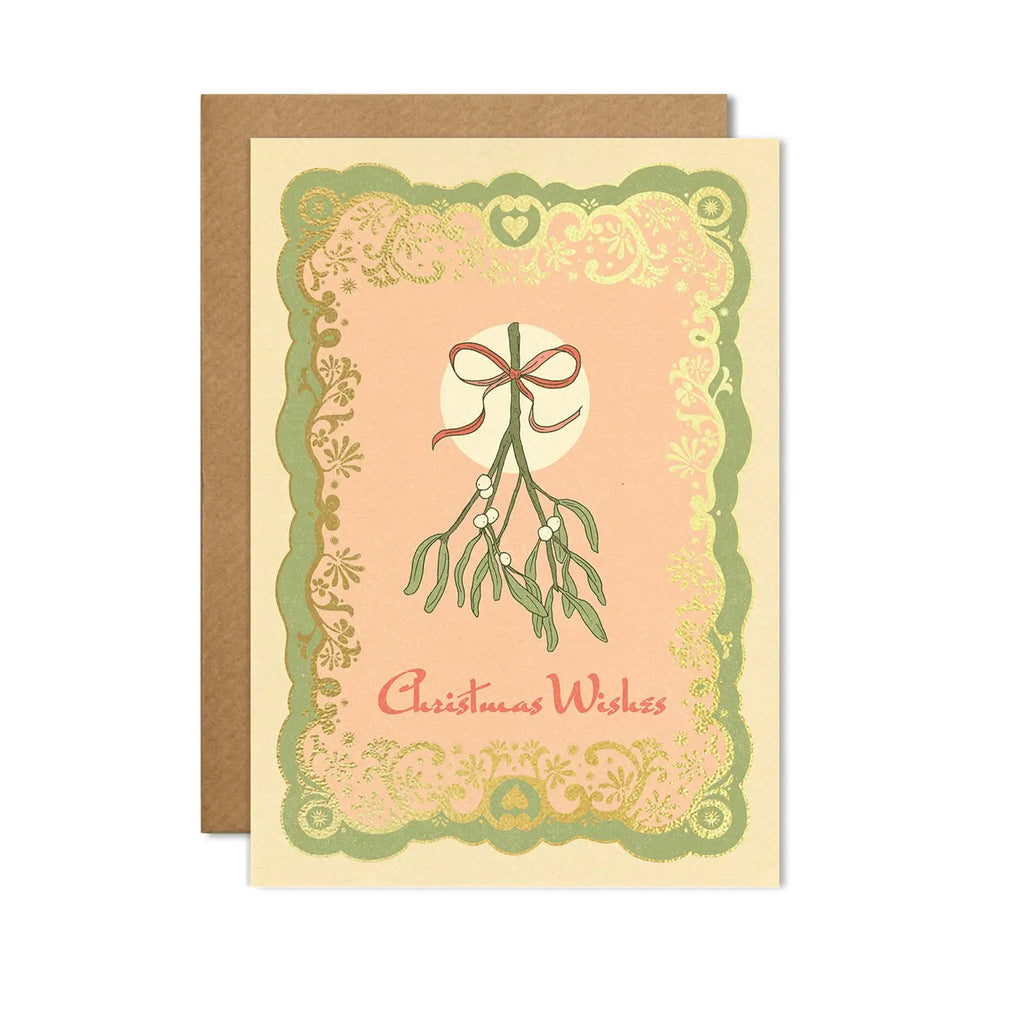 A greetings card designed by Cai and Jo, featuring a mistletoe design accented with green, pink and gold foil. Designed by Cai and Jo, available at Wanderlust Life.