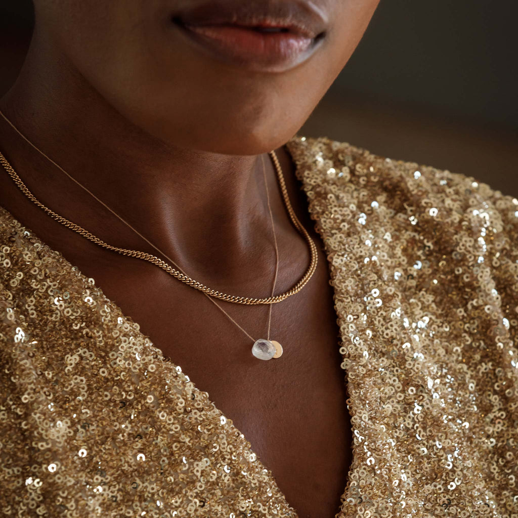 A substantial curb chain necklace makes a sophisticated everyday favourite; styled in a layered necklace stack with a minimal fine cord gemstone necklace.