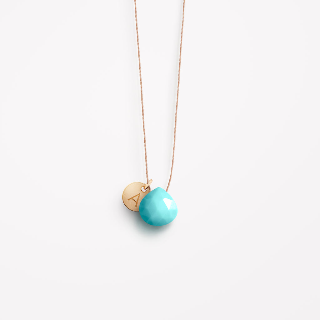 Wanderlust Life Ethically Handmade jewellery made in the UK. Minimalist gold and fine cord jewellery. december birthstone, arizona turquoise fine cord necklace with personalised gold tag. Personalised December birthstone necklace made in the UK.
