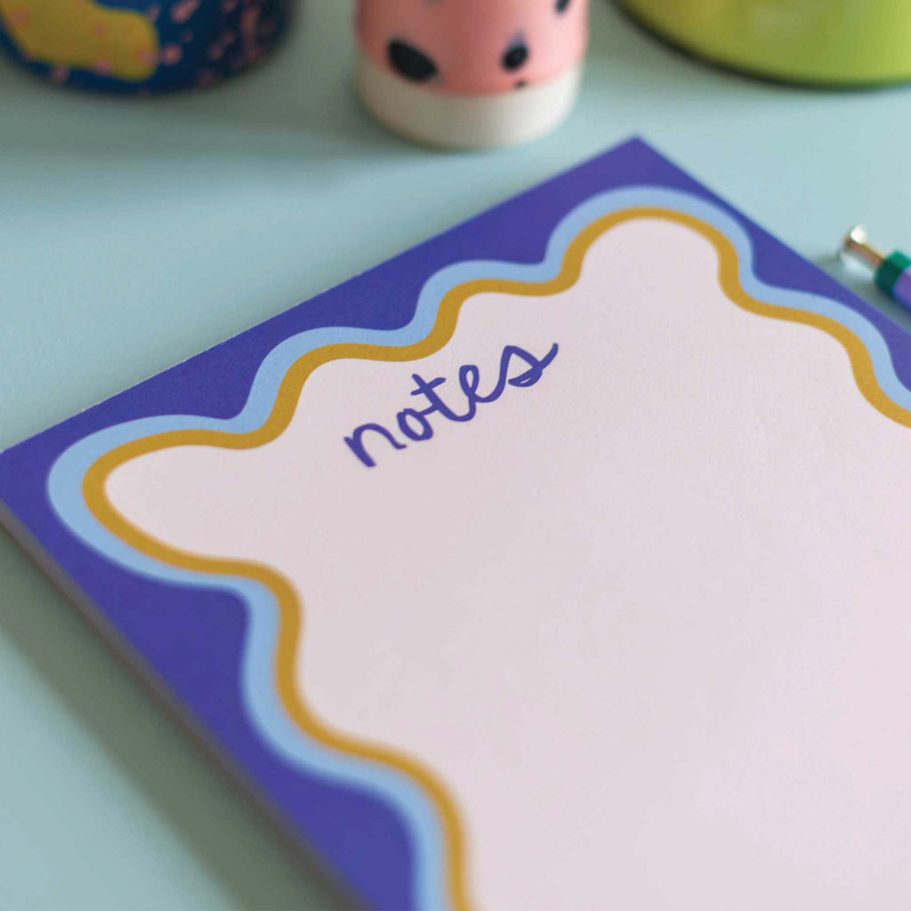 An A5, compact notepad with a wavy blue, seventies inspired border. Perfect for jotting down your brilliant ideas and to-do lists.