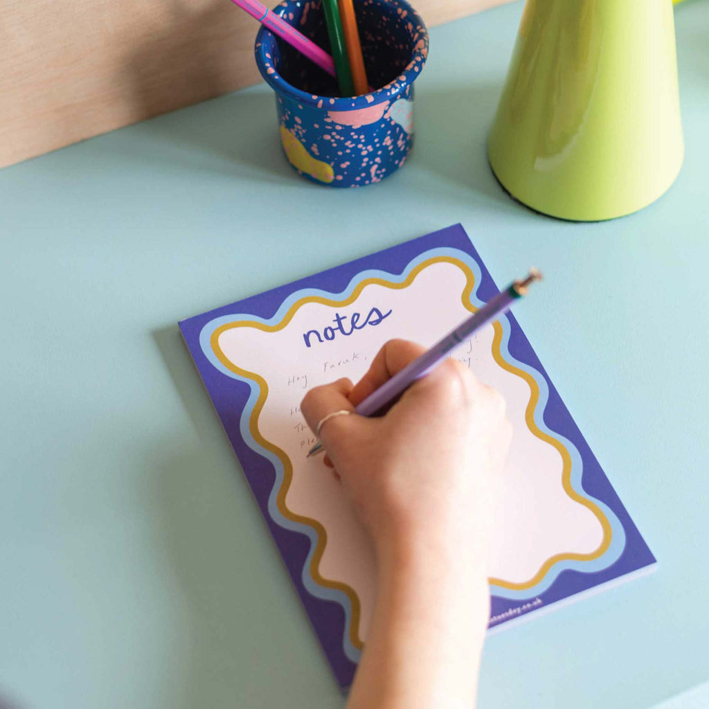 An A5, compact notepad with a wavy blue, seventies inspired border. Perfect for jotting down your brilliant ideas and to-do lists.