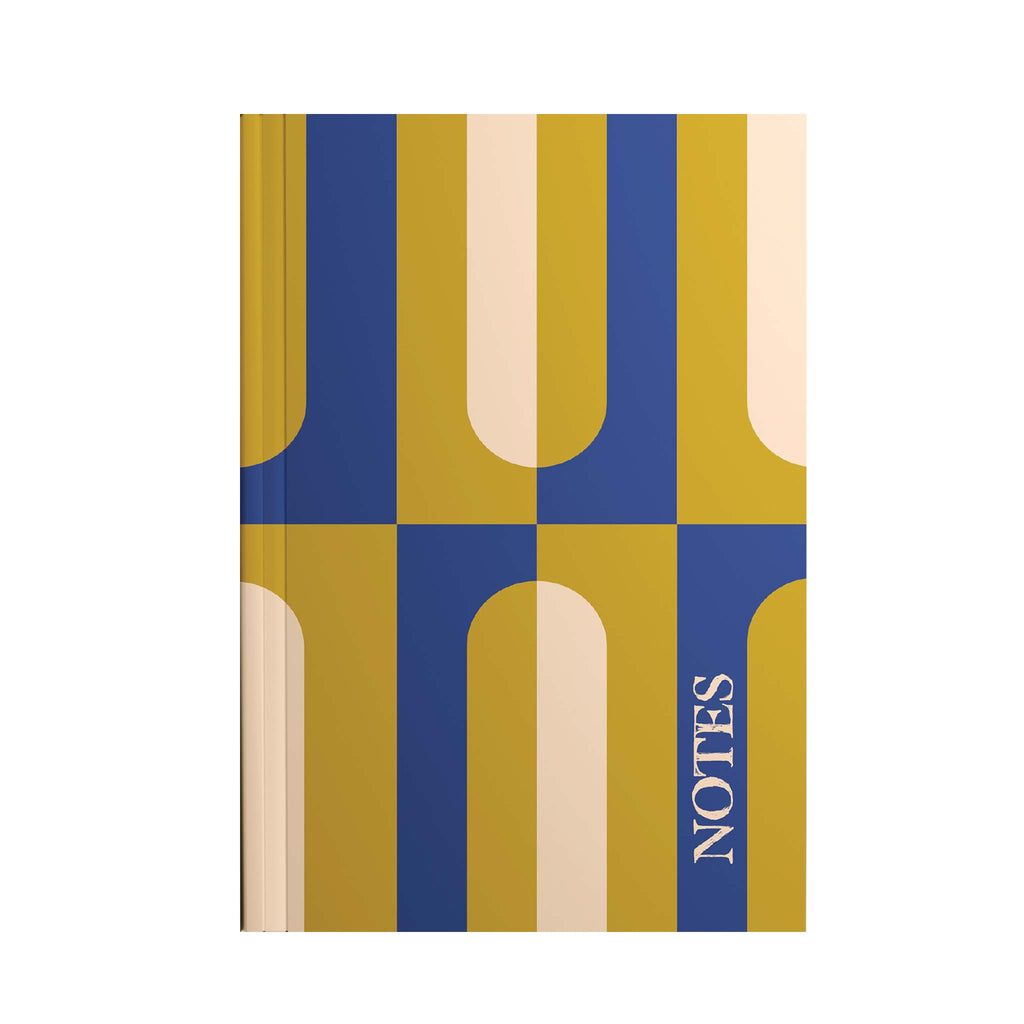 An A5 notebook featuring a chartreuse and navy blue geometric design.