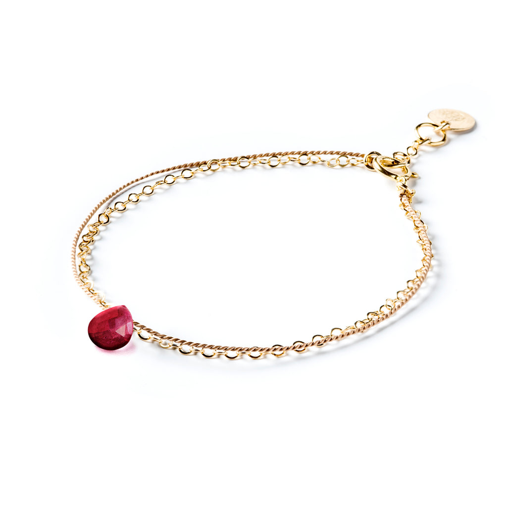 July Birthstone Bracelet with a ruby red gemstone. Creating the appearance of two bracelets layered into a stack, this gemstone bracelet combines a layer of silk and a layer of gold fill chain. Wanderlust Life’s signature aesthetic of minimal, modern and meaningful jewellery. Shop affordable birthstone jewellery online, perfect for birthday gifts. 