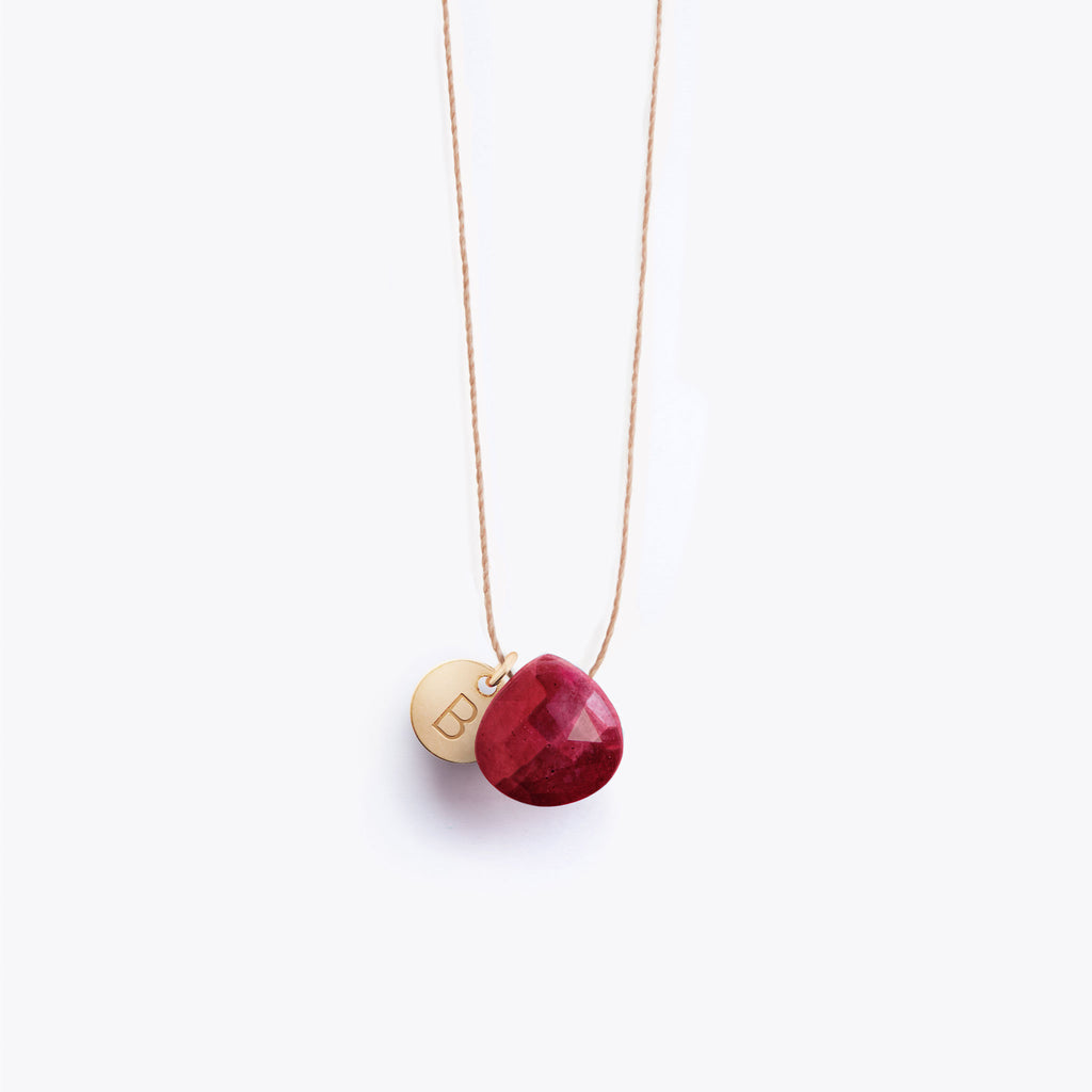 Wanderlust Life Ethically Handmade jewellery made in the UK. Minimalist gold and fine cord jewellery. Personalised ruby gemstone fine cord necklace with gold hand stamped personalisation tag