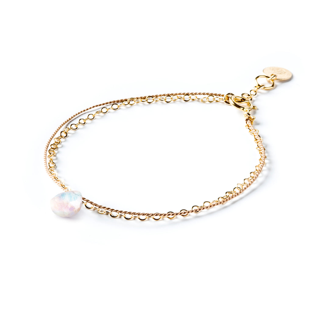 June Birthstone Bracelet with a rainbow moonstone gemstone. Creating the appearance of two bracelets layered into a stack, this gemstone bracelet combines a layer of silk and a layer of gold fill chain. Wanderlust Life’s signature aesthetic of minimal, modern and meaningful jewellery. Shop affordable birthstone jewellery online, perfect for birthday gifts. 