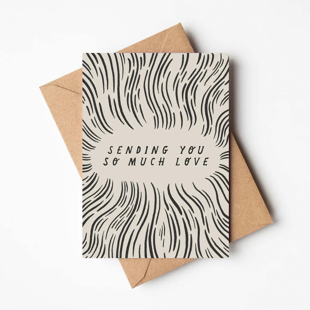 Black and white, monochrome design with flowing lines. Greetings card reads 'sending you so much love'. Brown envelope included.