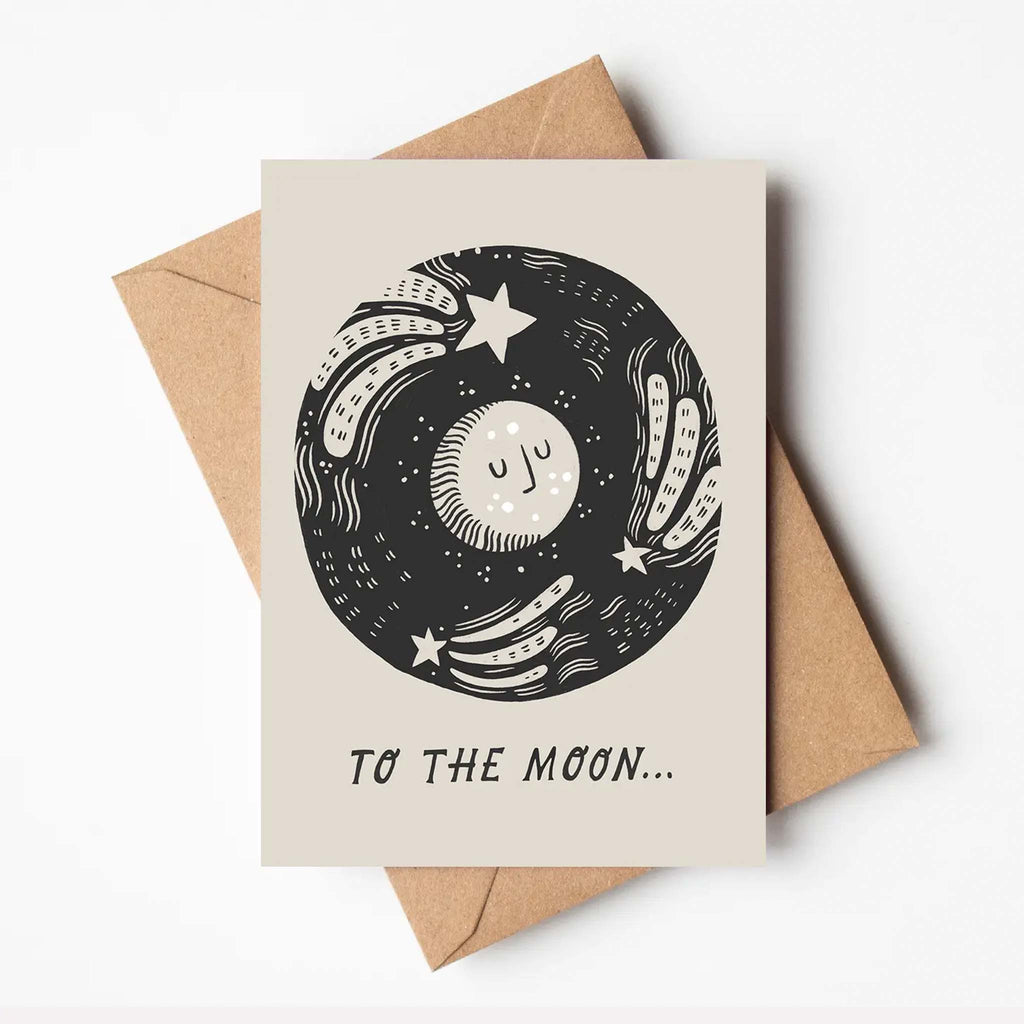 Monochrome illustration of the sky and moon, with the message 'to the moon'. Brown envelope included, A6 size.