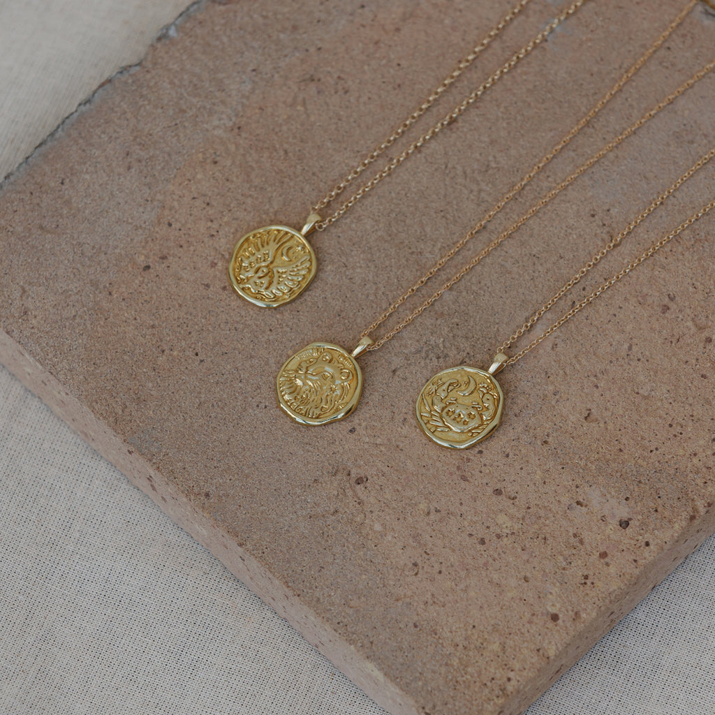 Libra, Leo and Cancer Zodiac coin pendant necklaces on 14k gold fill chains.