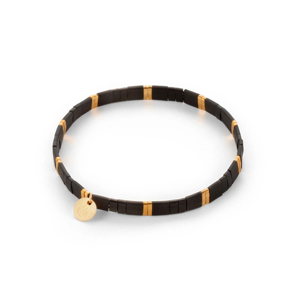 The Moonlight Layering Bracelet is a modern and minimal beaded bracelet. Elasticated for a comfortable fit. The bracelet is made with alternating black and gold beads.