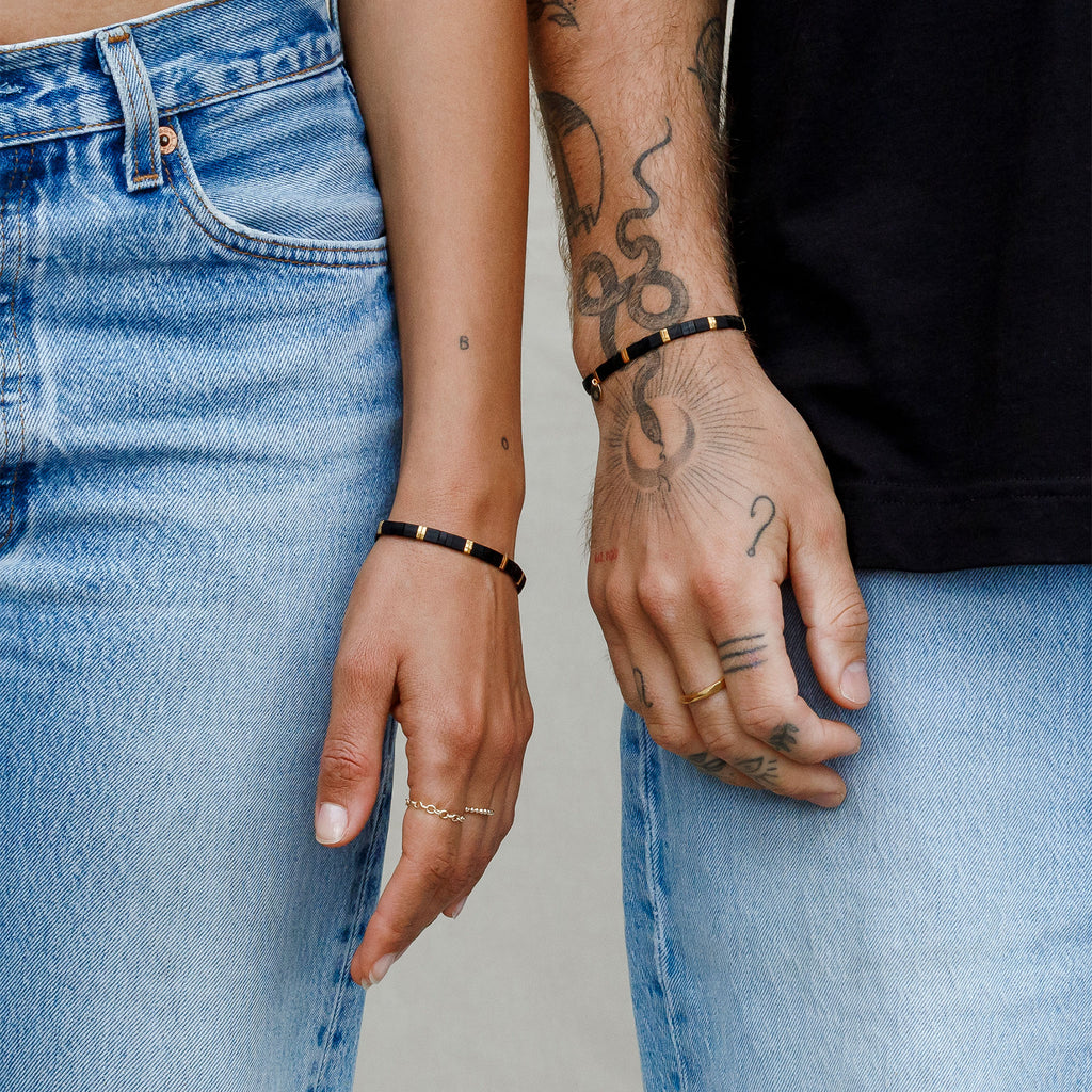 Worn by both men and women, the Moonlight Layering Bracelet is a beaded, elasticated bracelet featuring black and gold beads. Shop affordable beaded jewellery at Wanderlust Life.