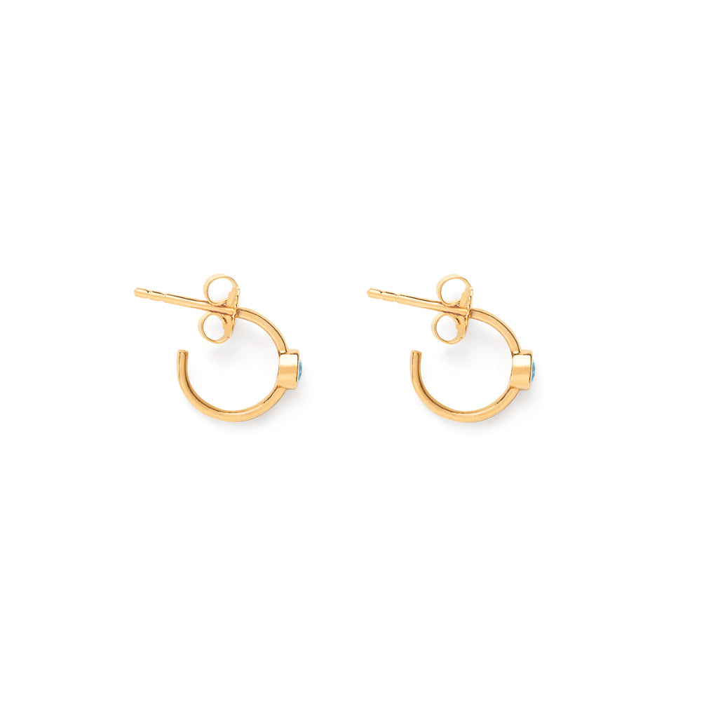 Meaningful birthstone earrings for November feature round topaz gemstones fixed upon the surface of three-quarter hoops. Create a meaningful ear stack with your birthstone earrings, style with hoops or studs to create a unique, everyday ear stack. 14k gold vermeil, affordable everyday jewellery. Designed in Devon and handcrafted by our Wanderlust Life Global Artisan Partners.