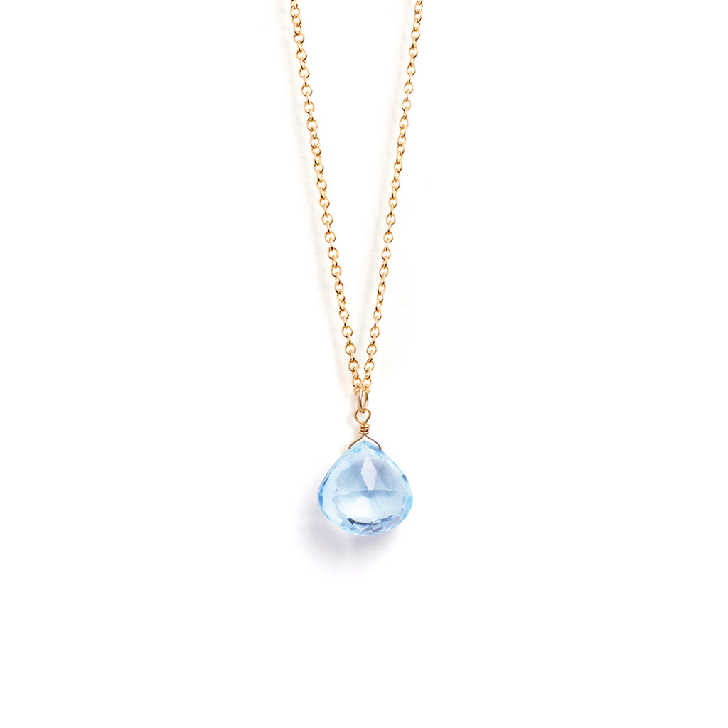 A November birthstone necklace features a blue topaz gemstone on a minimal 14k  gold fill chain.