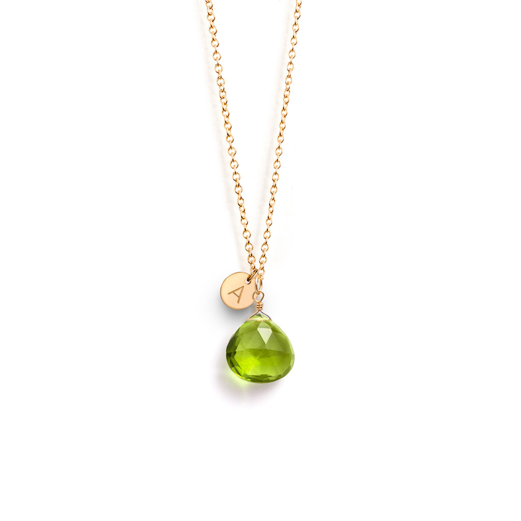 An August birthstone necklace features a lime green peridot gemstone on a gold fill chain.
