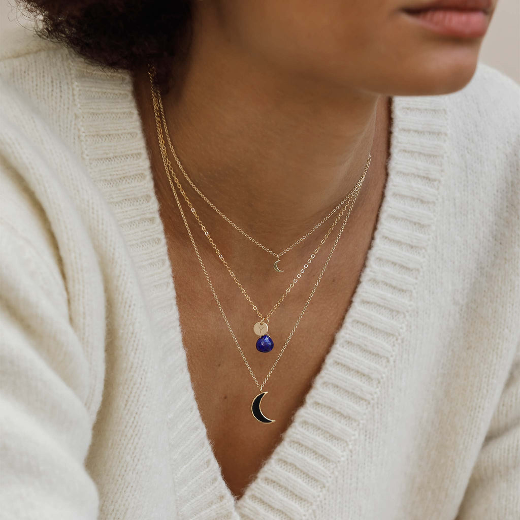 Personalised with a monogram tag, a lapis lazuli gemstone hands from a minimal and adjustable gold-fill chain. Choose your initial to personalise your necklace.