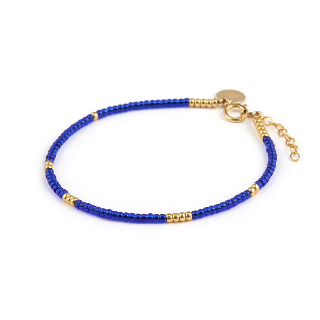 Cobalt blue beads contrast with a pattern of gold beads. A vibrant and adjustable bracelet, designed and handcrafted in our Devon studio.