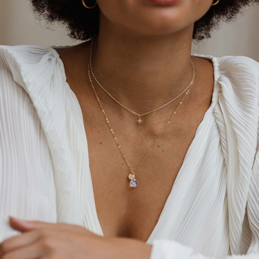 Personalised with a monogram tag, this Rainbow Quartz gemstone necklace hangs on a minimal gold-fill chain, with an 'M' initial charm. Shop personalised jewellery.