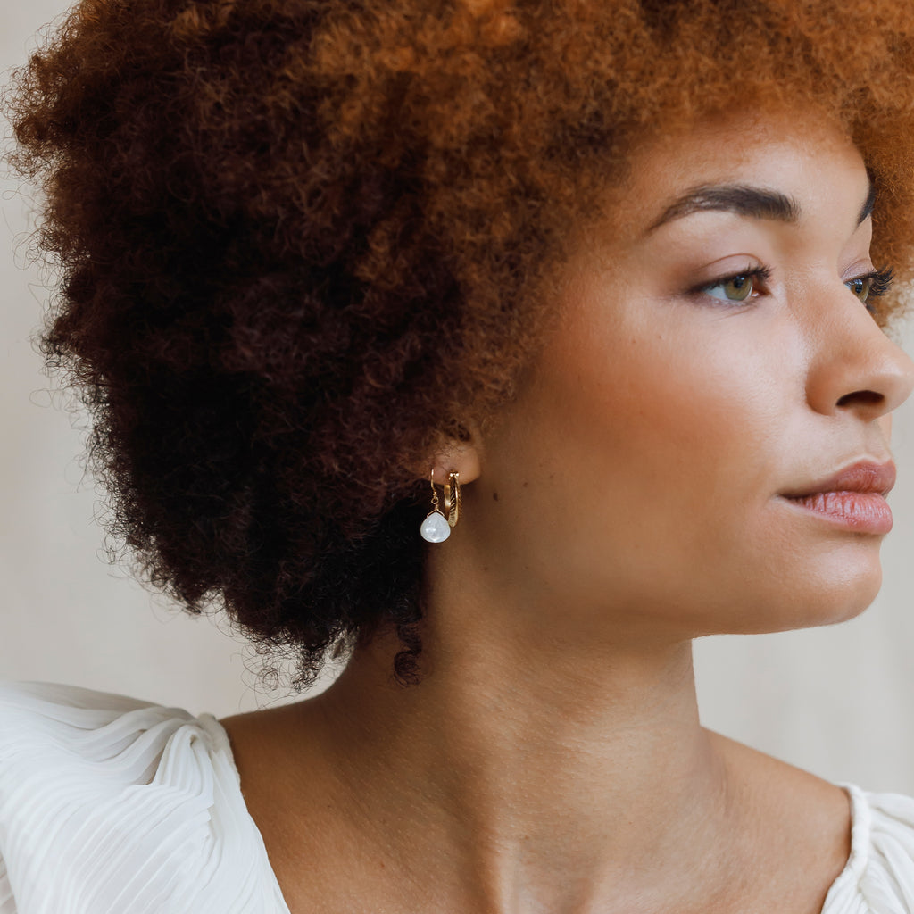 Plumo Gold Hoop Earring styled with mother of pearl isla drop earrings.
