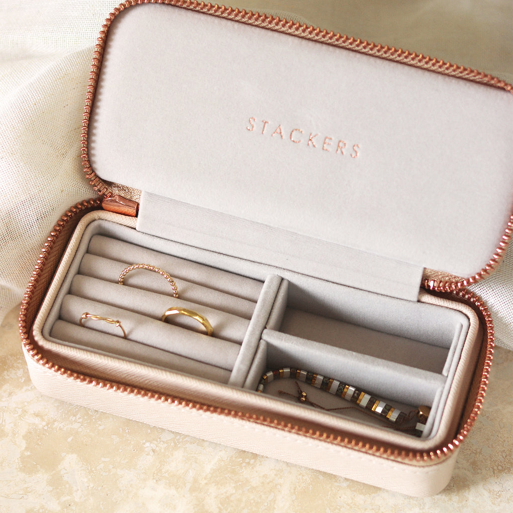 Designed by Stackers, the blush pink faux leather travel jewellery box featuring a rose gold zip. With a soft velvet lining for safely storing jewellery whether at home or travelling. Shop Stackers online at Wanderlust Life.