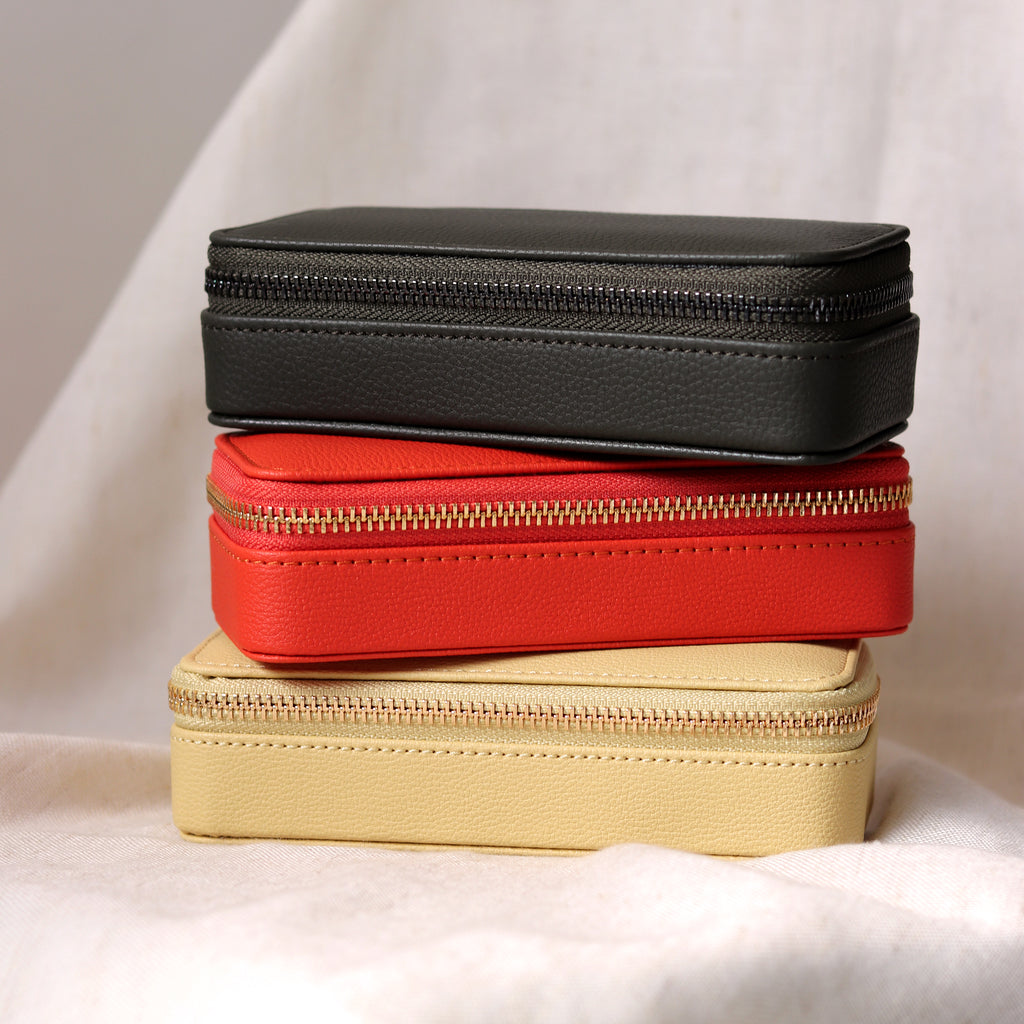 A stack of the medium jewellery travel boxes by Stackers. Choose from pastel yellow, vibrant orange or olive green. 