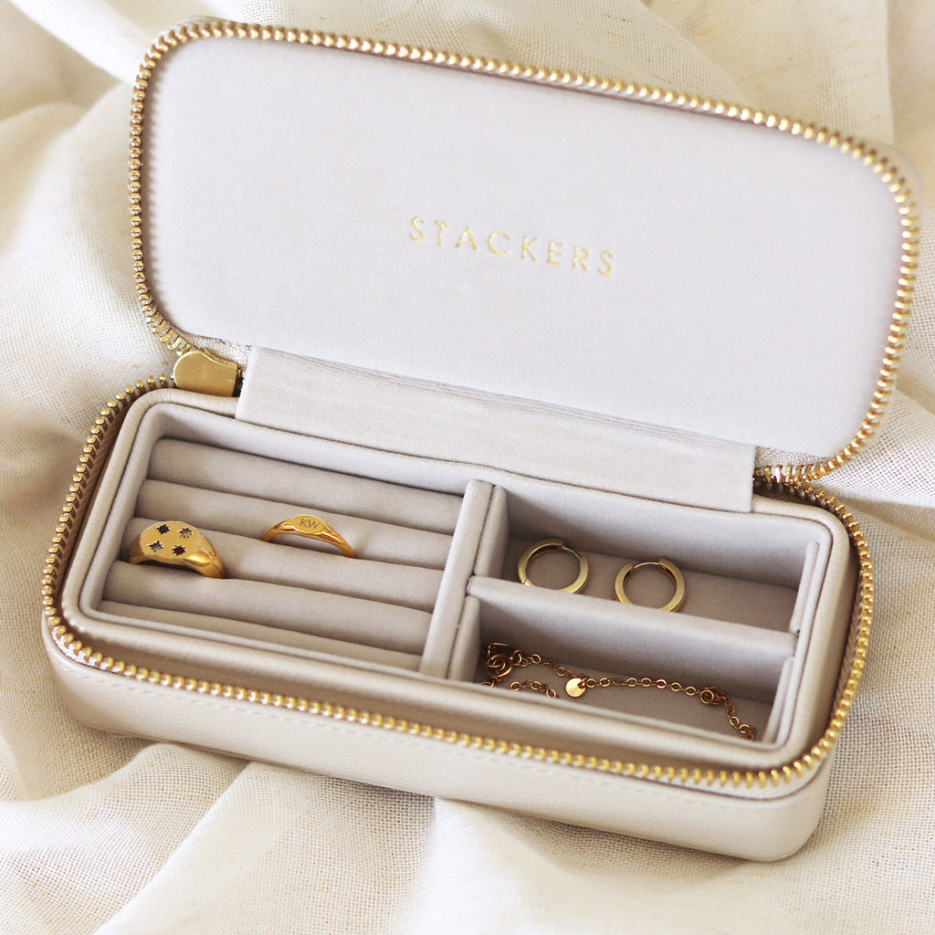 Designed by Stackers, the medium sized jewellery travel box in Oatmeal. With sections designed for rings, earrings and bracelets; store your jewellery within the velvet lined compartments. A gold colour zip fastens the box closed. Shop jewellery storage online at Wanderlust Life.