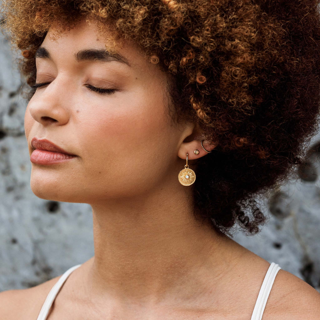 The Solstice Ear Cuff is styled in an ear stack with Opal stud earrings and statement charm hoop earrings.