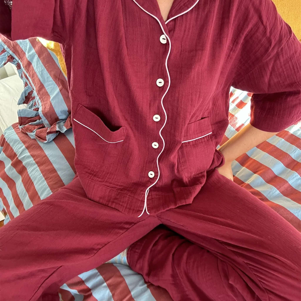 Burgundy button shirt pyjamas with scalloped piping detail.