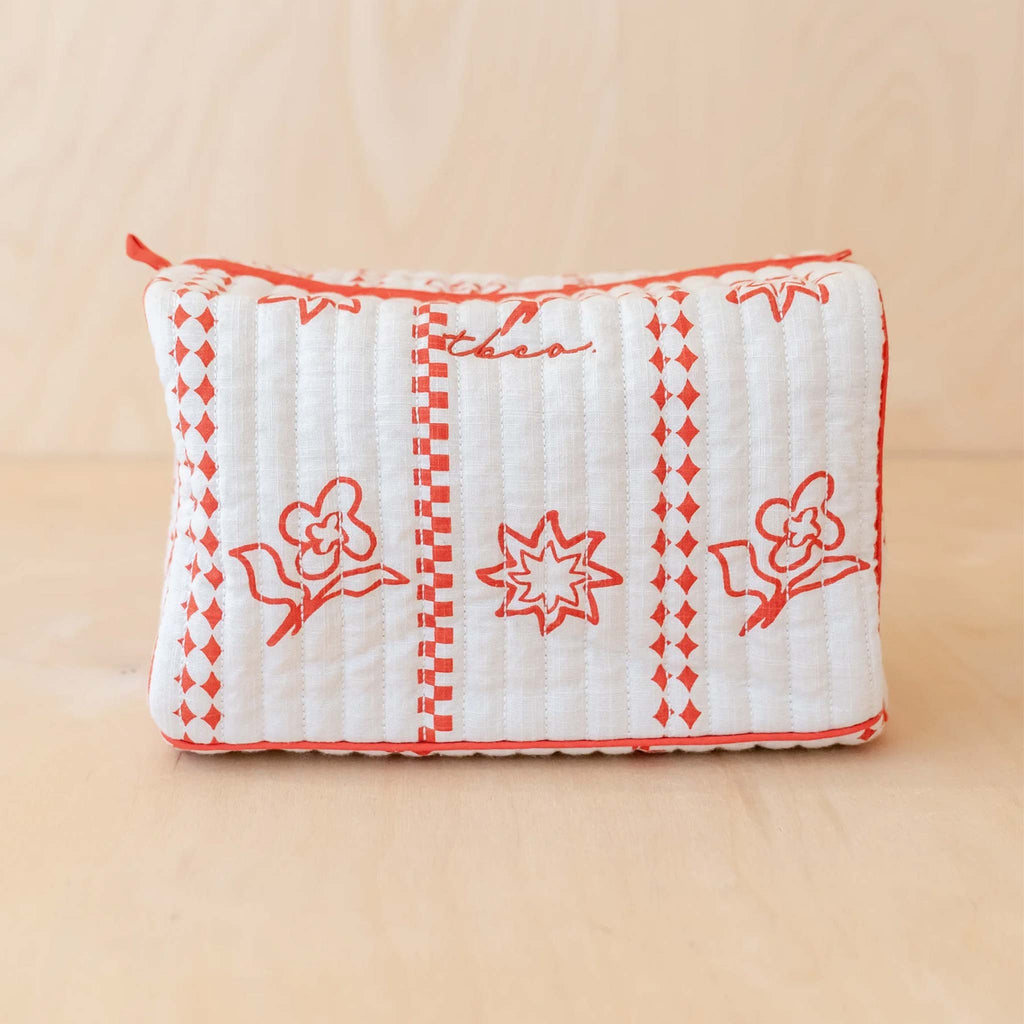 rectangular wash bag in white cotton, with red floral pattern. 