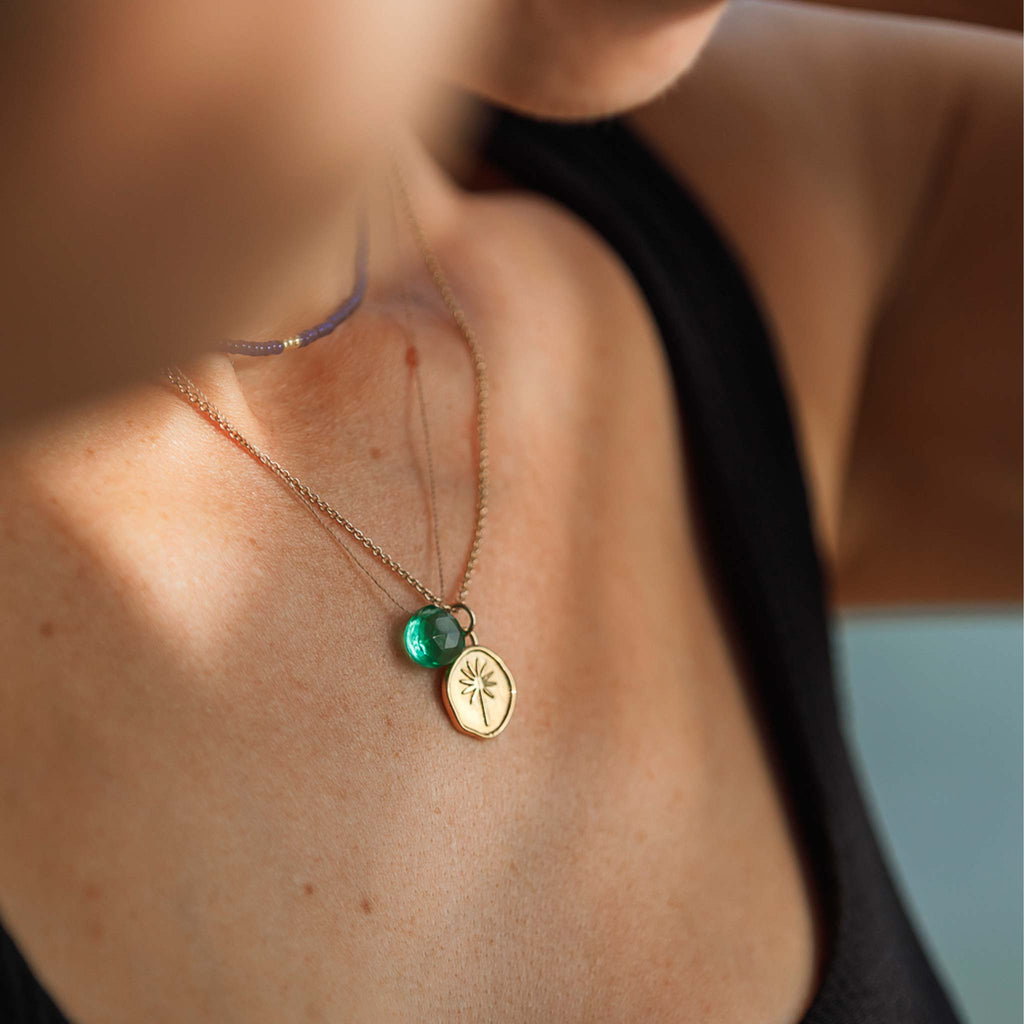 The Seafoam Green Quartz Fine Cord Necklace worn with the Terra Pendant Necklace which features a palm tree.