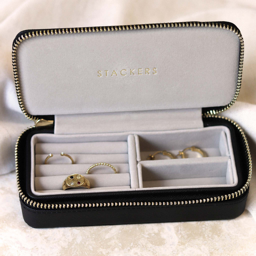 Medium size travel jewellery box with faux leather black exterior, and a faux velvet soft interior. With compartments designed for storing rings and earrings.
