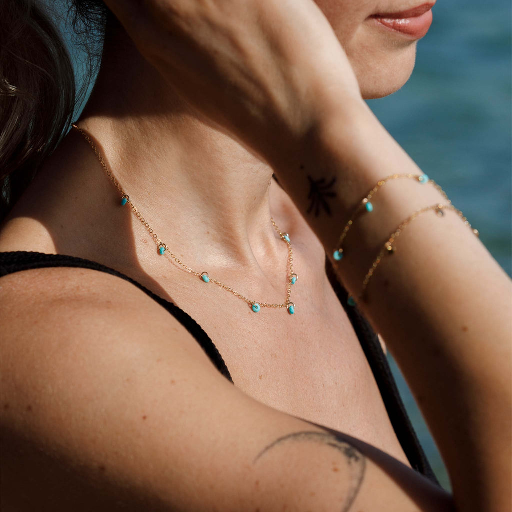 The Turquoise Telltale Necklace is a short length layerign chain, made with 14k gold fill and features turquoise rondels placed at regular intervals like charms.