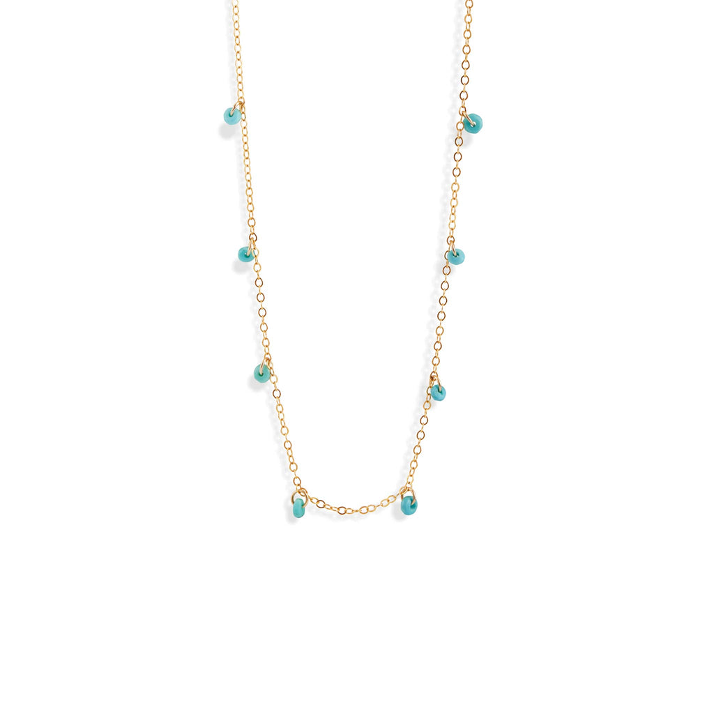 Faceted turquoise rondels are fastened at regular intervals to a minimalist gold chain necklace