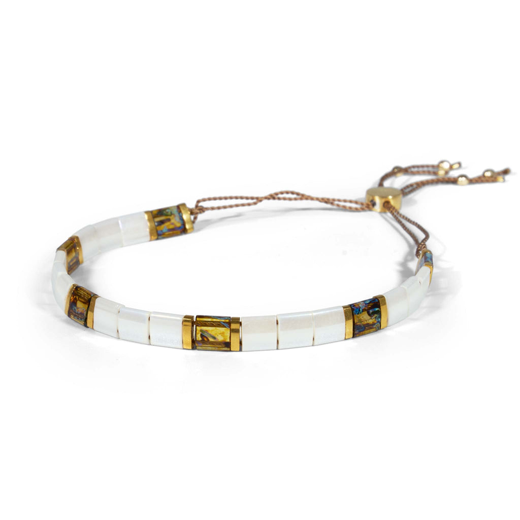 A reimagined version of our bestselling terrazzo bracelet, this pearly mosaic bracelet blends dreamy pearlescent glass tiled beads with tortoiseshell beads and gold accents. Handcrafted with nylon cord and 14k gold vermeil findings.