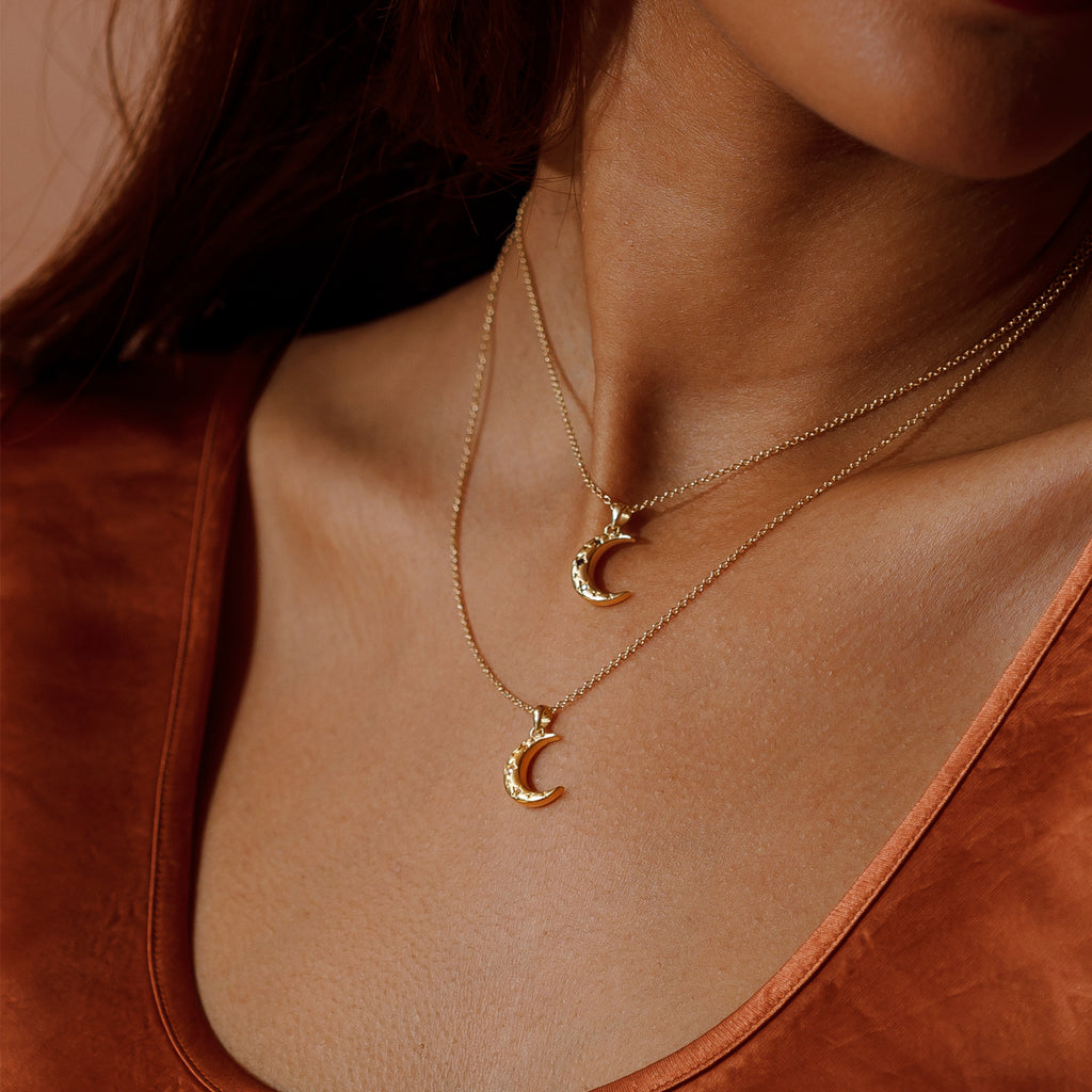 Double moon pendant layered stack of the white topaz Carina Crescent necklace and the Limited Edition black diamond Lunara necklace.