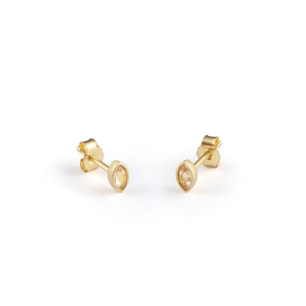 A delicate elliptical bezel setting surrounds a shimmering White Topaz on a stud earring.