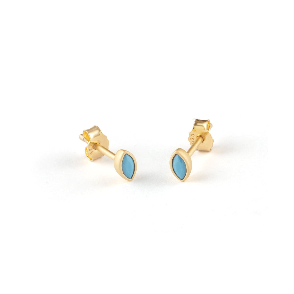 Elliptical like an eye, these minimalist gold vermeil stud earrings feature lab-created turquoise gemstones.