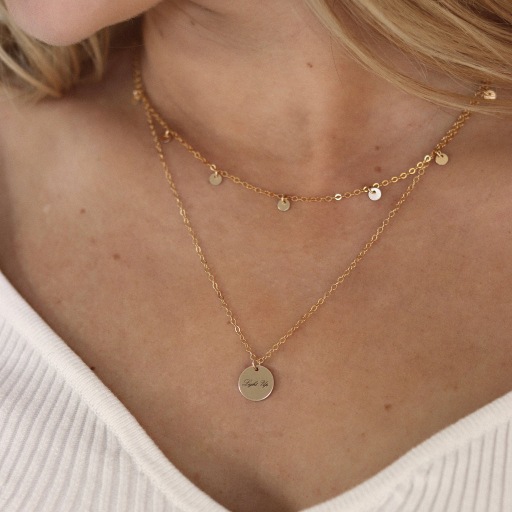 Wanderlust Life Jewellery bestselling Telltale Necklace. 14k gold fill discs adorn this delicate gold chain necklace. A statement choker to wear alone or style a layered up look. Affordable, everyday luxury jewellery. Perfect for gifting. Proudly designed and handcrafted in our Devon studio.