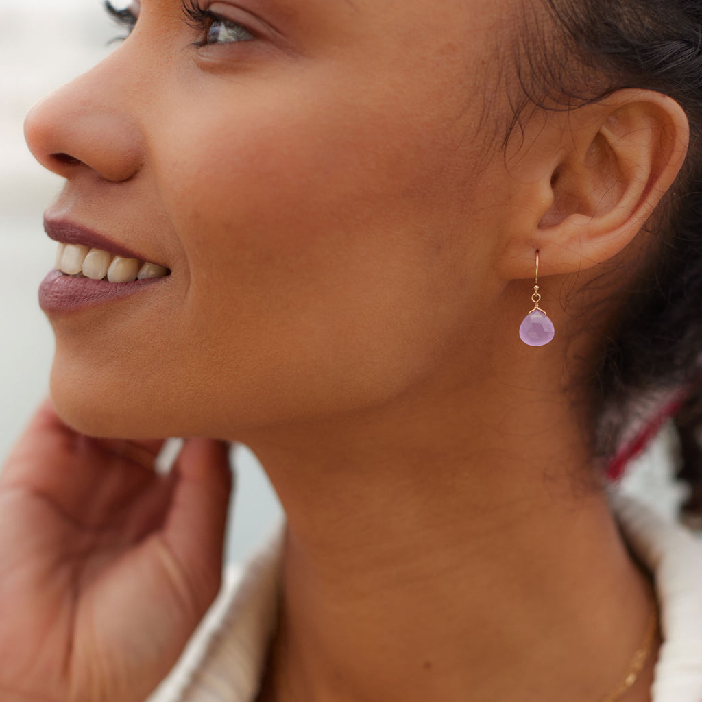 Wanderlust Life Lilac Jade Isla Drop Earrings. Model wears our lilac purple drop earrings in our bestselling, signature Isla Drop Earrings.