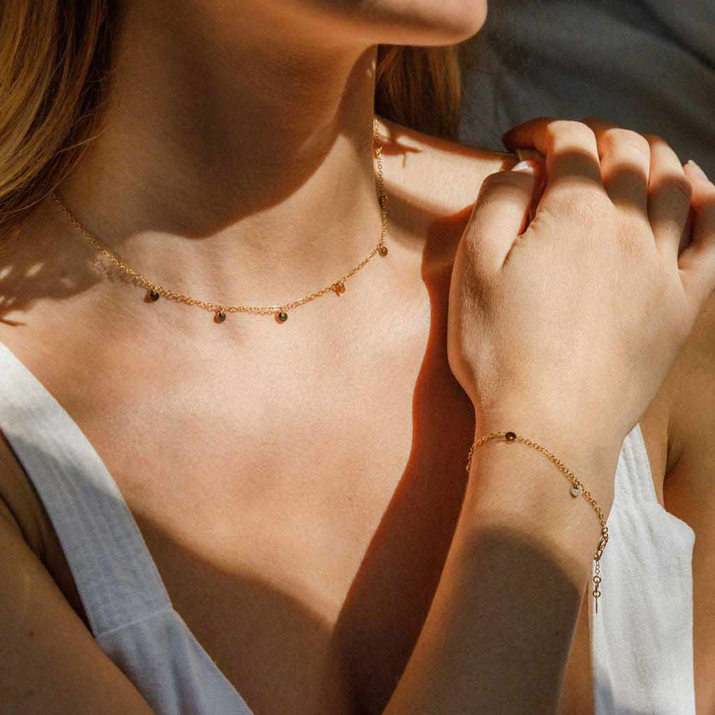 Wanderlust Life Jewellery bestselling Telltale Necklace. 14k gold fill discs adorn this delicate gold chain necklace. A statement choker to wear alone or style a layered up look. Affordable, everyday luxury jewellery. Perfect for gifting. Proudly designed and handcrafted in our Devon studio.