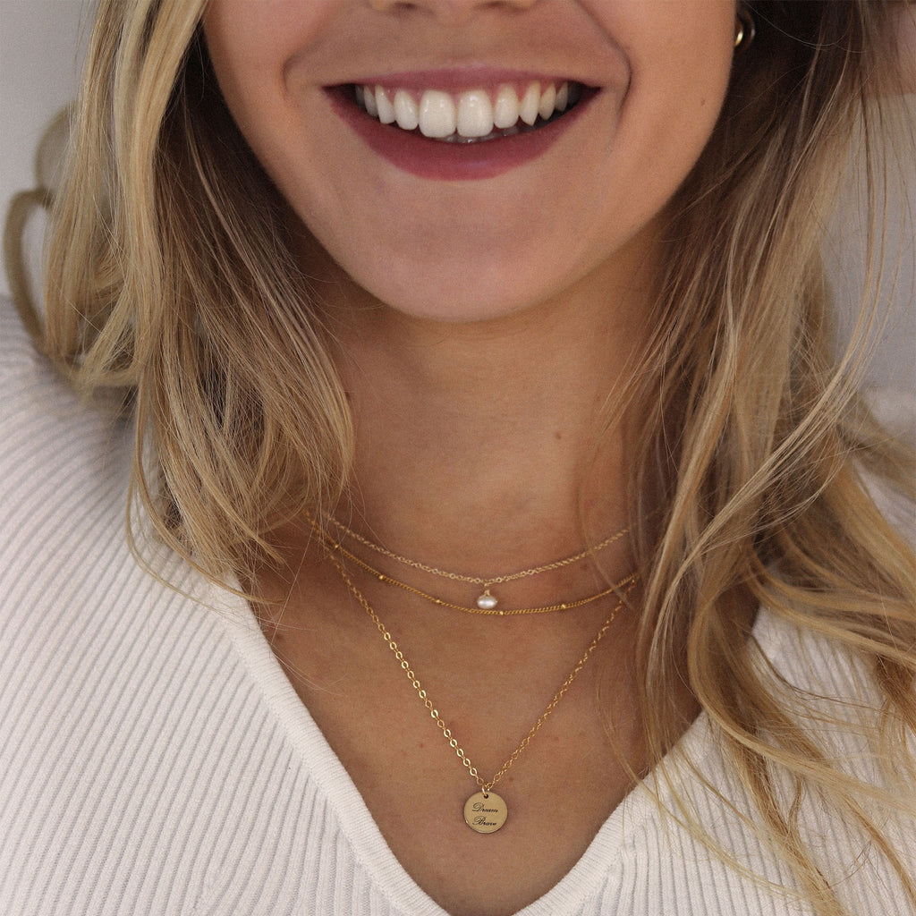 Wanderlust Life Petite Pearl Pendant Necklace. A minimal pearl drop hangs from a choker style 14k gold fill chain. Perfect for layering with Wanderlust Life necklaces. Proudly designed and handcrafted in our studio in Devon, UK.