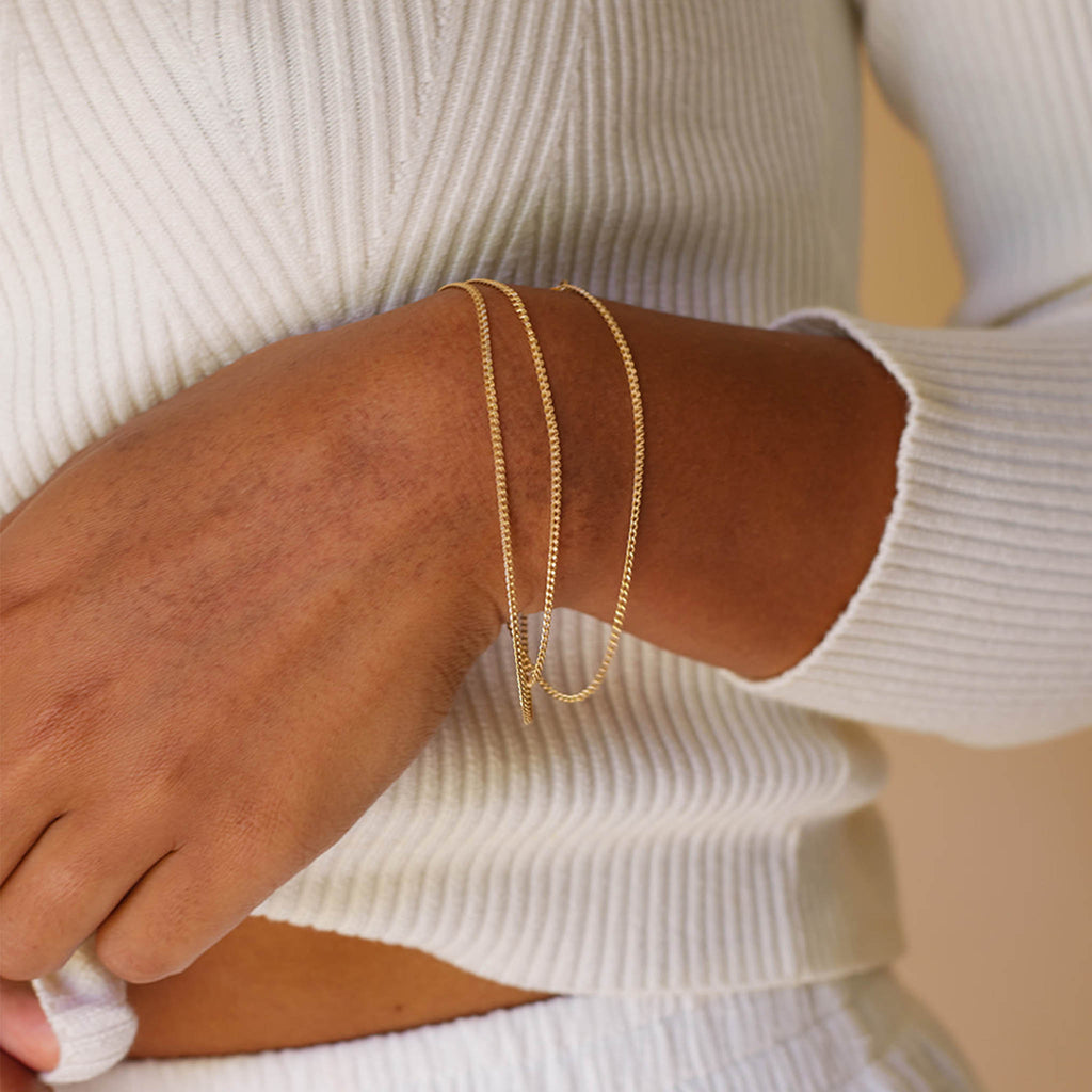 Gold Chain Bracelet, Celine. This versatile flat, slinky curb 20.5 inch bracelet is a two-in-one piece designed to be worn as a necklace or wrapped twice around the wrist as a bracelet. Proudly designed in Devon & handcrafted by our Wanderlust Life jewellery makers in the UK.