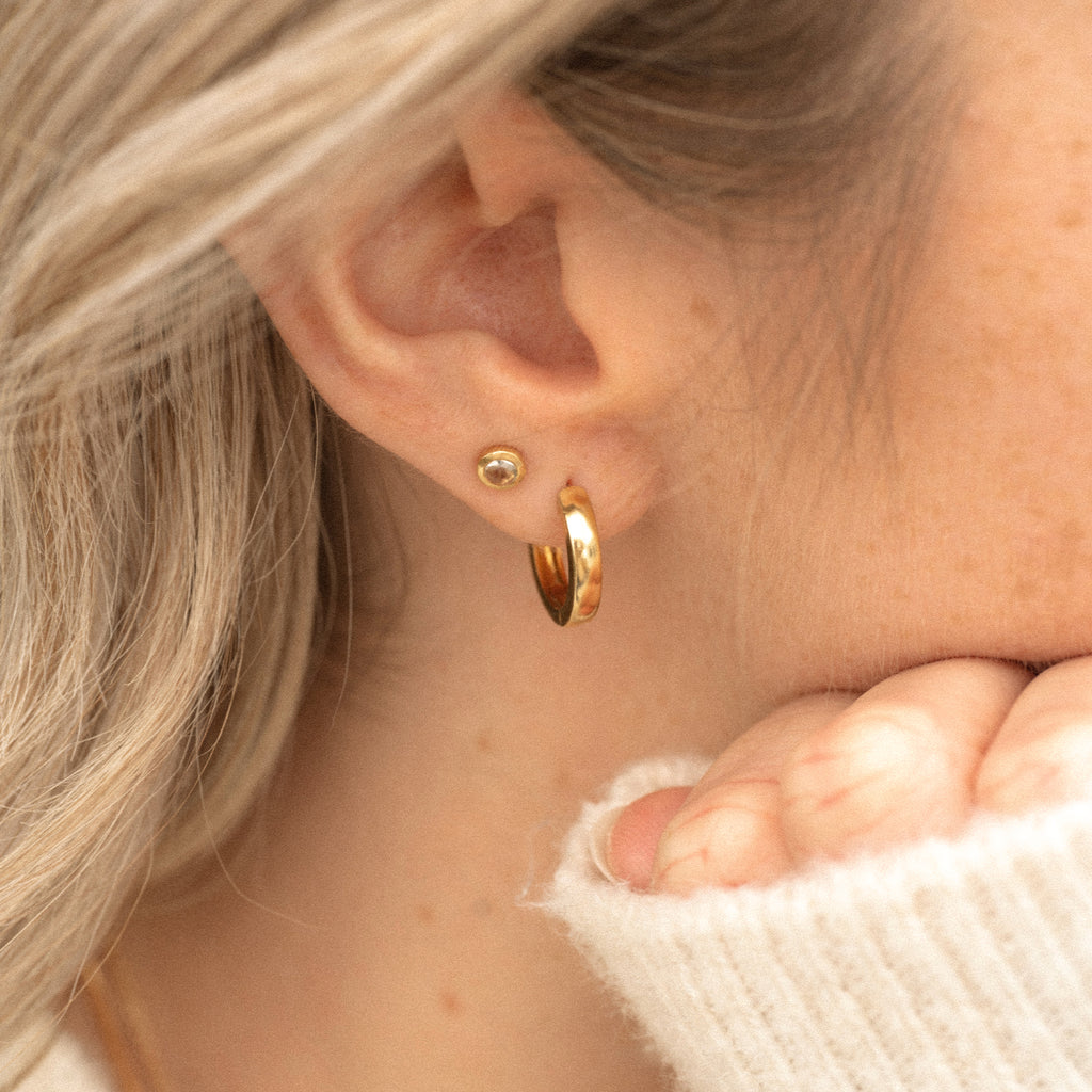 Wanderlust Life Ethically Handmade jewellery made in the UK. Minimalist gold and fine cord jewellery. April birthstone gold stud earrings. Clear quartz gemstone earrings.