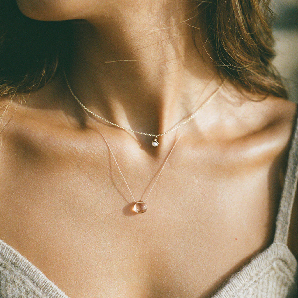 Wanderlust Life champagne quartz faceted gemstone in our signature fine cord necklace; layered with petite pearl choker necklace. Our fine cord necklaces are designed and handcrafted by our jewellery maker's in our Devon studio. Perfect for gifting. Affordable everyday jewellery.