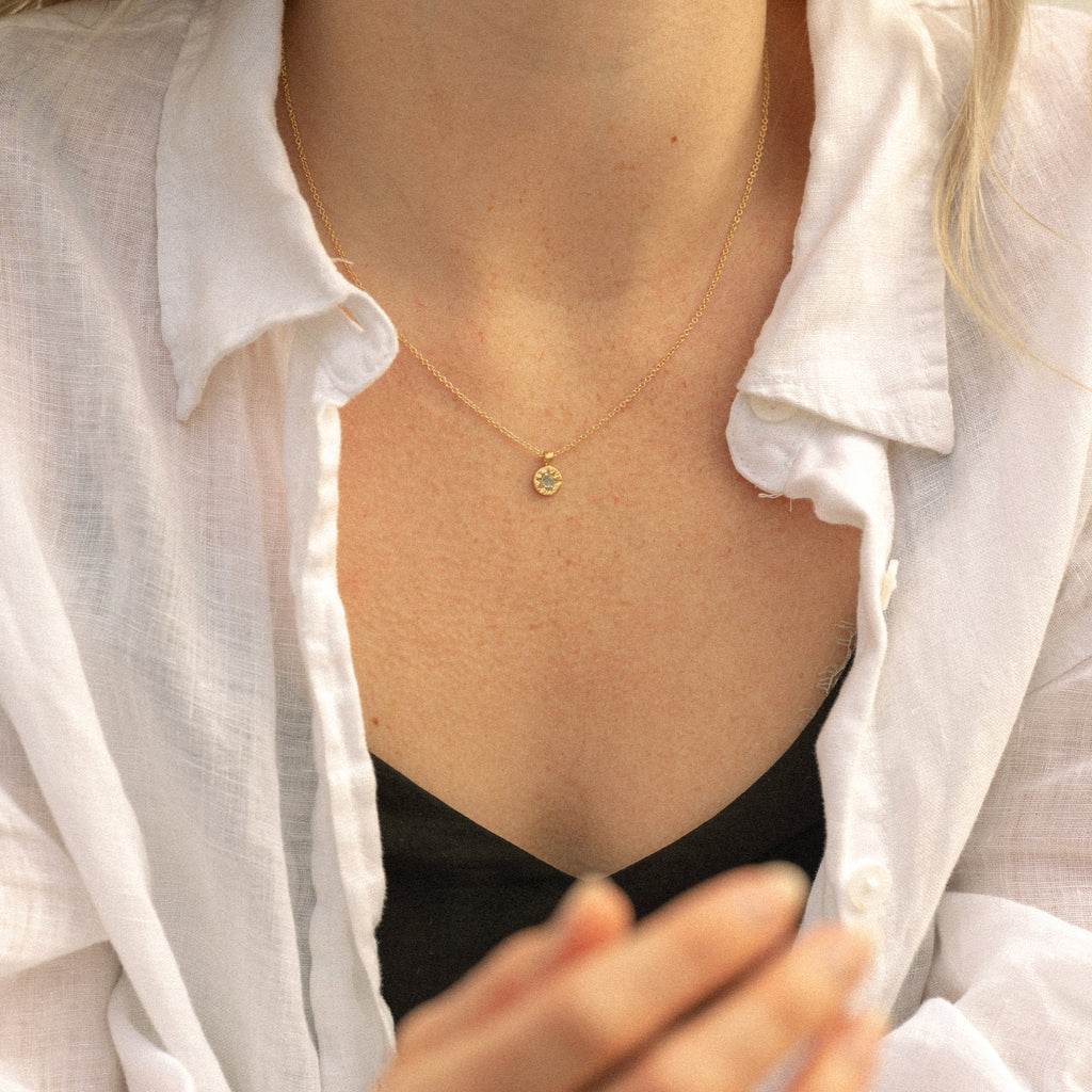 Wanderlust Life gold plated, March birthstone necklace with blue aquamarine semi precious gemstone. The perfect birthstone gift.