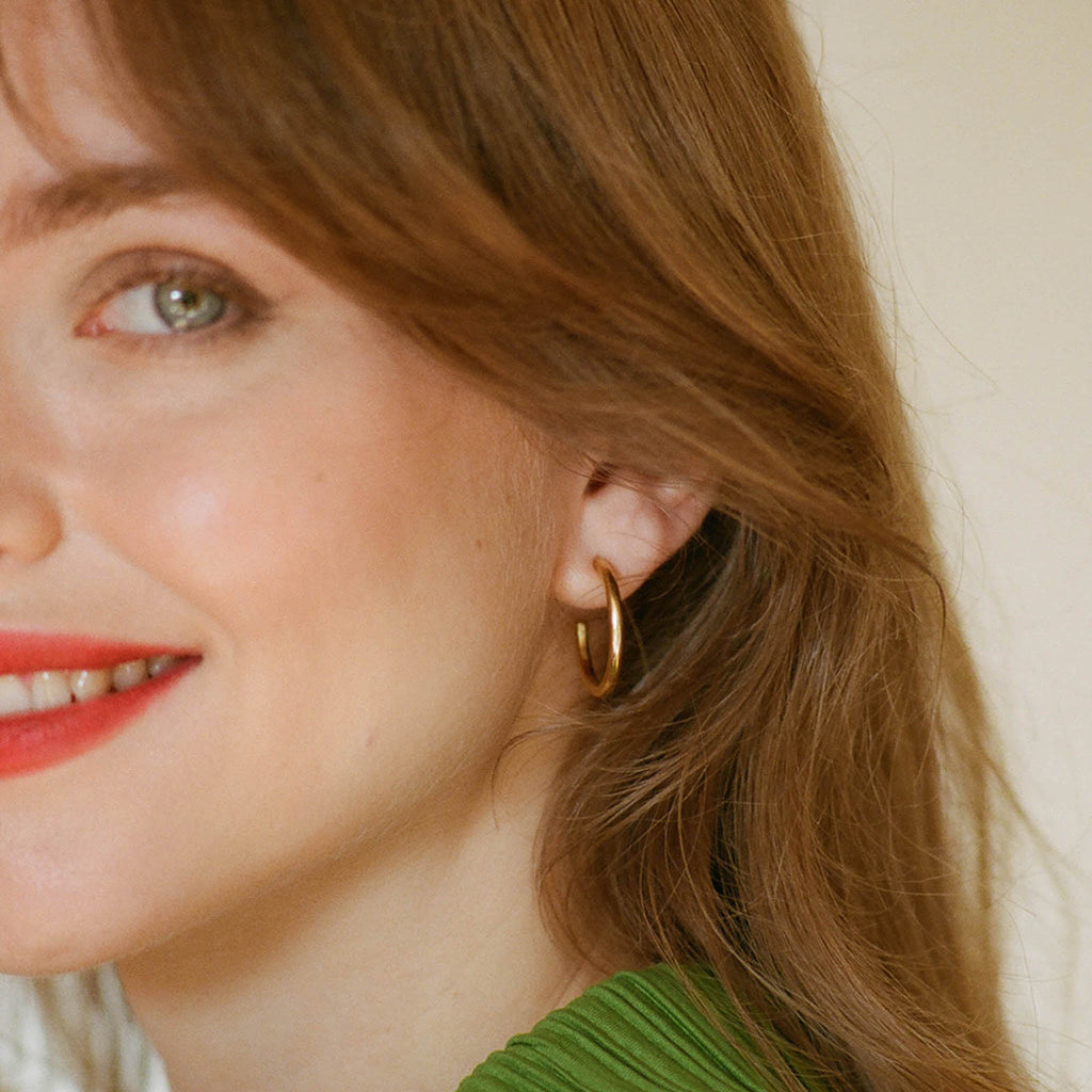 Silke Gold Hoop Earring, medium stud hoop earrings in silver plated in 14 carat gold. Proudly designed in Devon and crafted by our Wanderlust Life global artisan partners