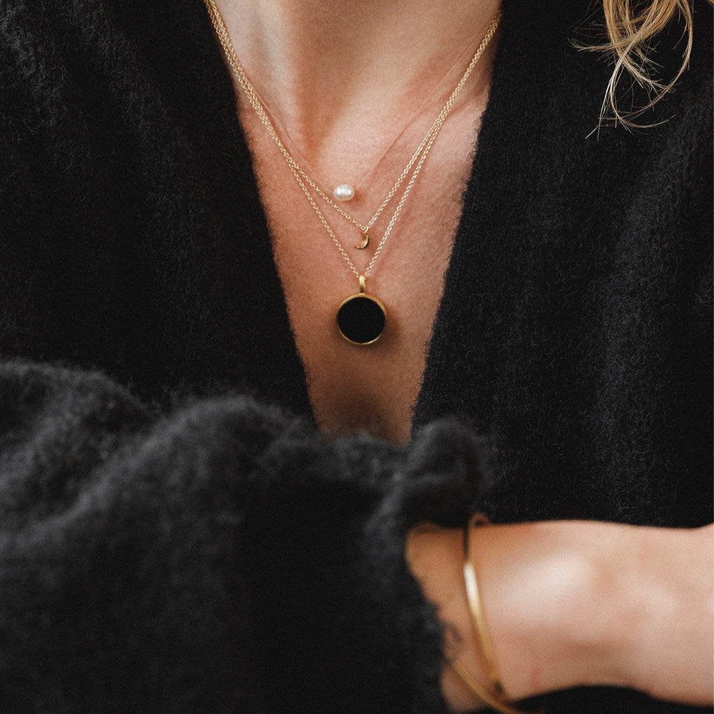 Wanderlust Life jewellery, porthole gold chain necklace with black onyx gemstone. Wanderlust Life handmade jewellery in the UK.